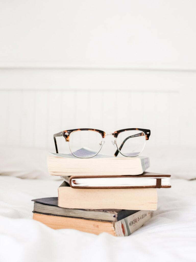 a stack of books and glasses