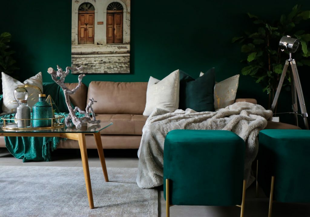 a room with green walls and a couch and a table with a camera on it