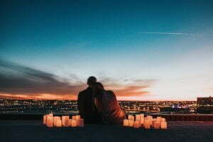 a couple kissing on a bridge