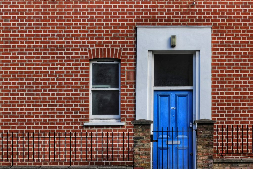 a blue door in a brick building