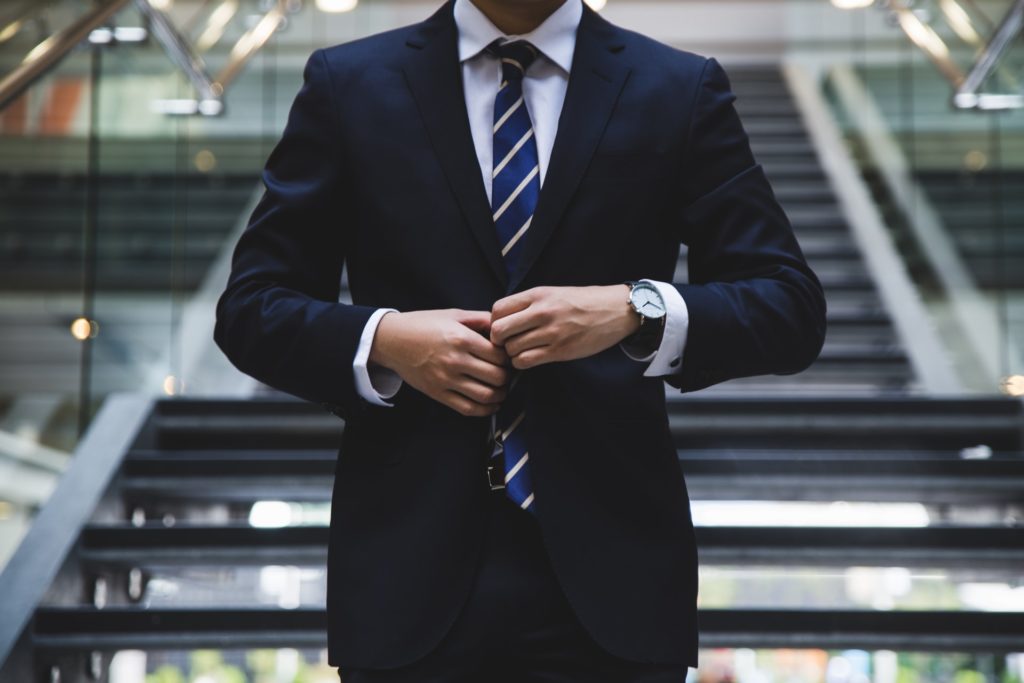 a man in a suit and tie shaking hands