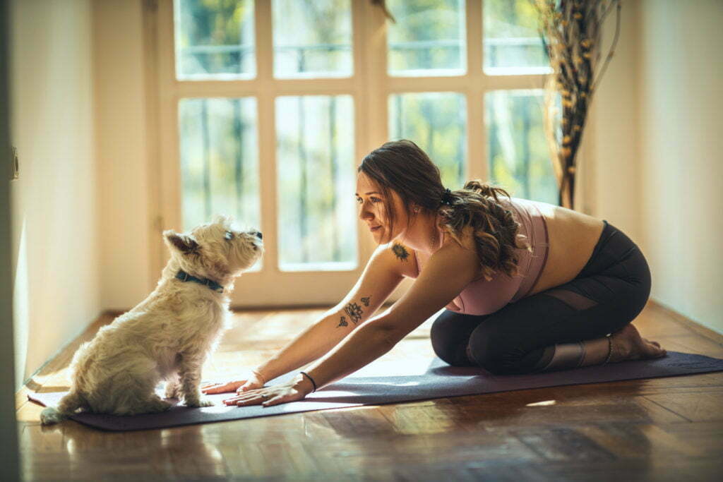 a woman and a dog sitting on the floor