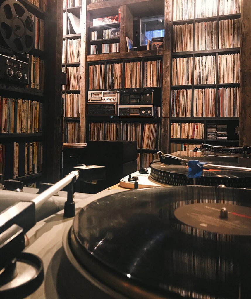 a room with a table and bookshelves