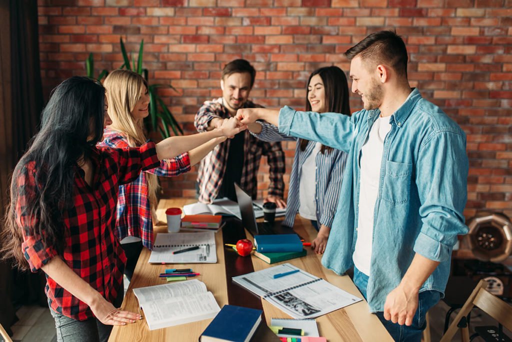 a group of people standing around a table