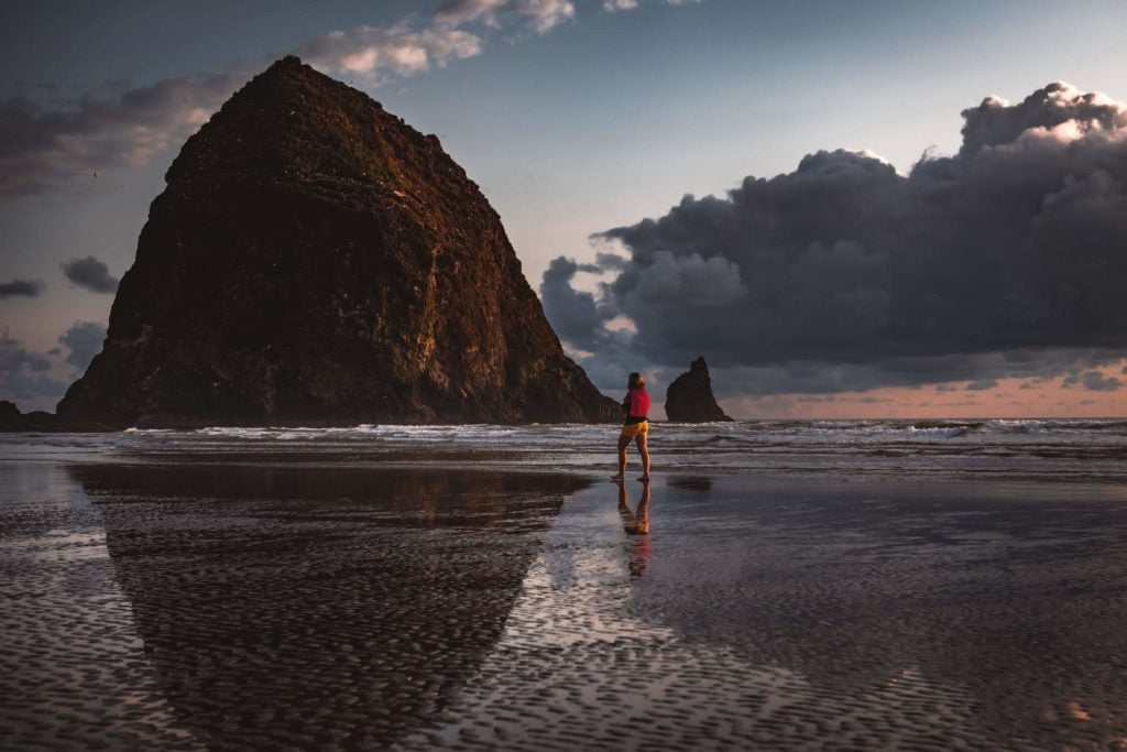 two people walking on a beach