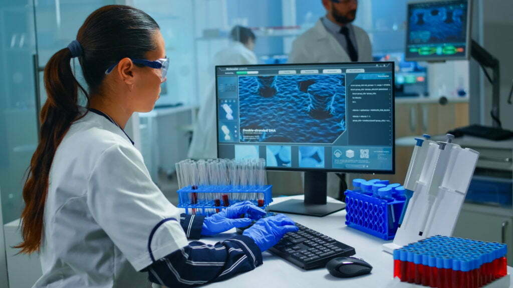 Woman technologist doing a laboratory test examining a flask with blood sample