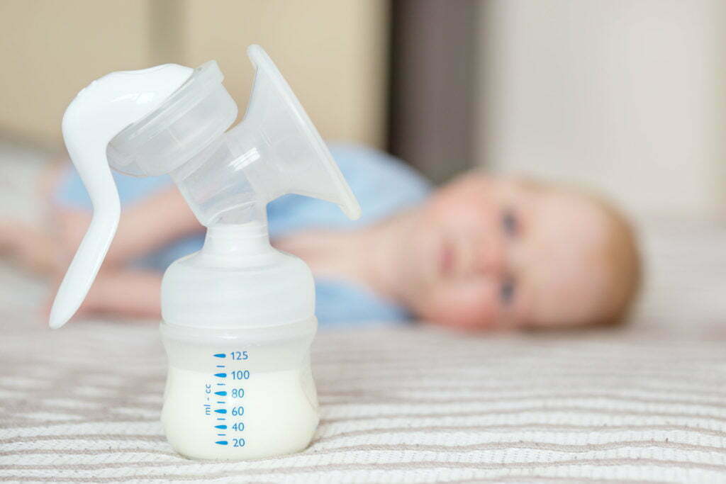 Breast pump with milk. The concept of childhood, motherhood, life style, upbringing.