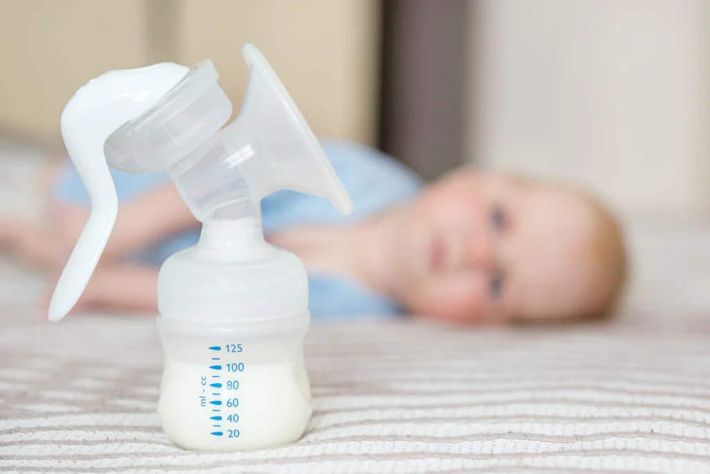 Breast pump with milk. The concept of childhood, motherhood, life style, upbringing.