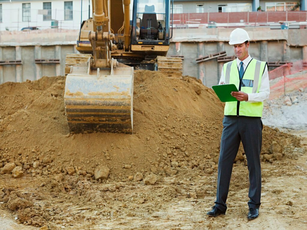 Mature man with clipboard on construction site