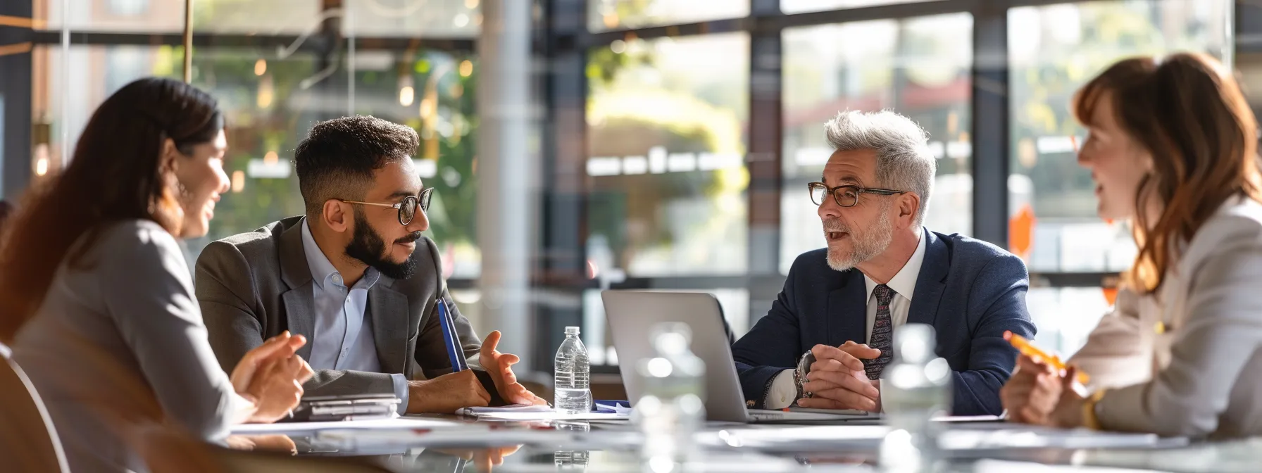 How Maximizing Tax-Smart Giving Enhances Your Philanthropic Impact 3 business professionals engaged in a focused discussion around a presentation on tax-smart giving strategies.
