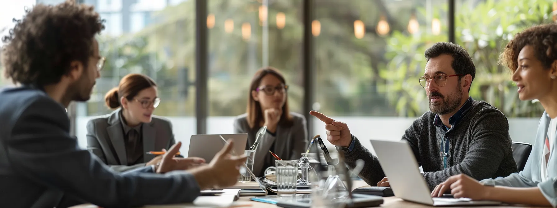 How Taking Online Courses Transforms Business Skills 2 a group of professionals engaged in a lively discussion around a table with laptops open, pointing at a visual representation of online communication courses.